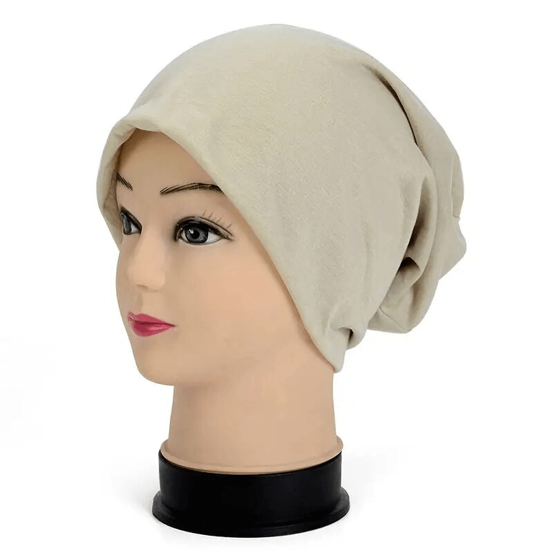 Beige cotton soft lightweight slouchy beanie on mannequin, perfect for running and outdoor activities, unisex and casual style.